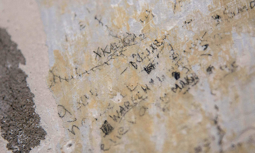 prisoner writings on the wall of Lyon’s notorious Montluc prison from which résistant and historian Marc Bloch